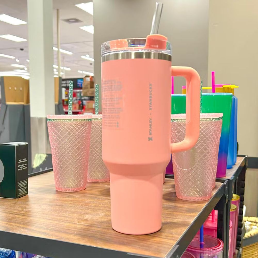 A Starbucks Stanley Collaboration tumbler with a white and pink design