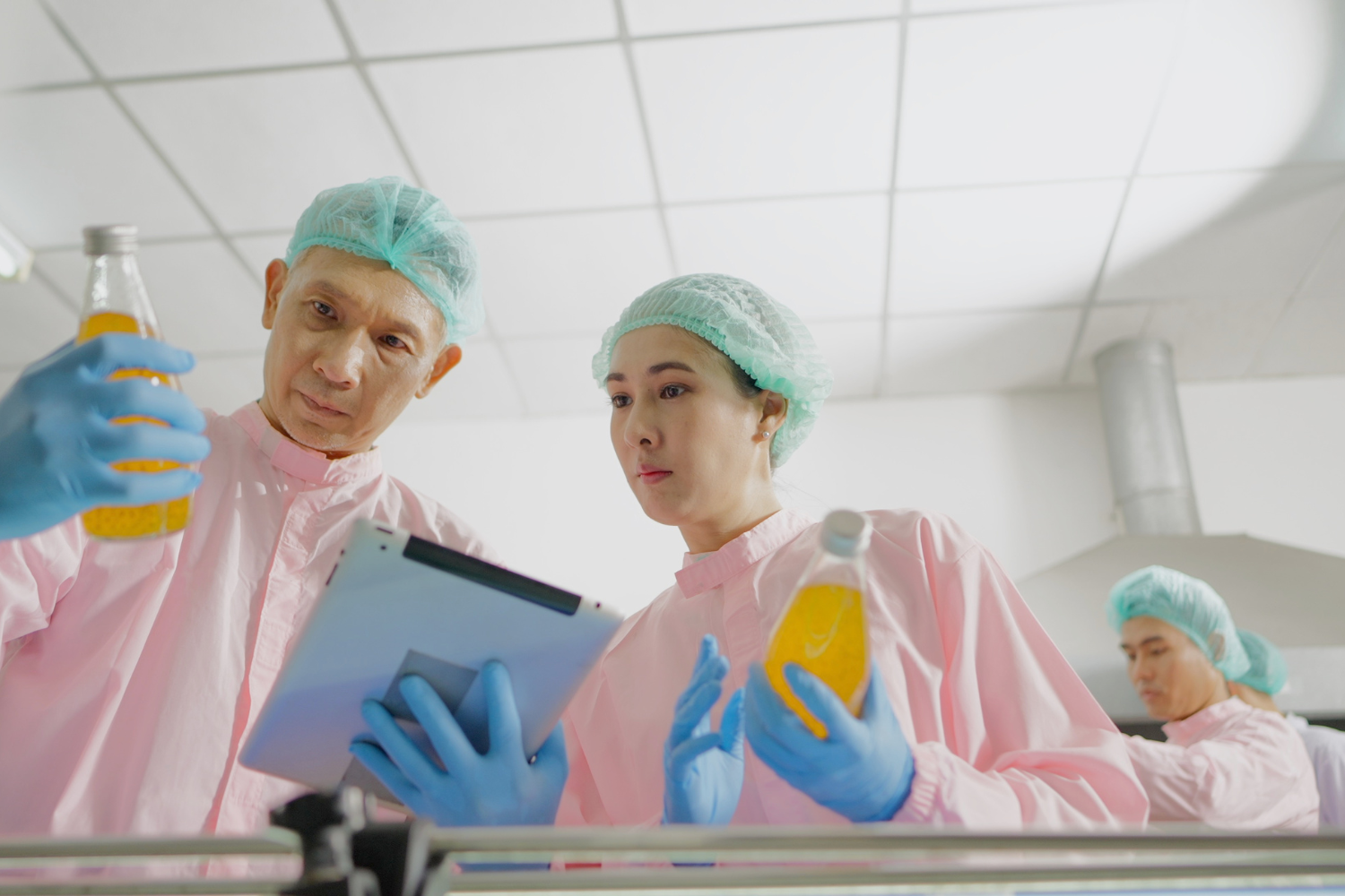 Two lab scientists checking products.