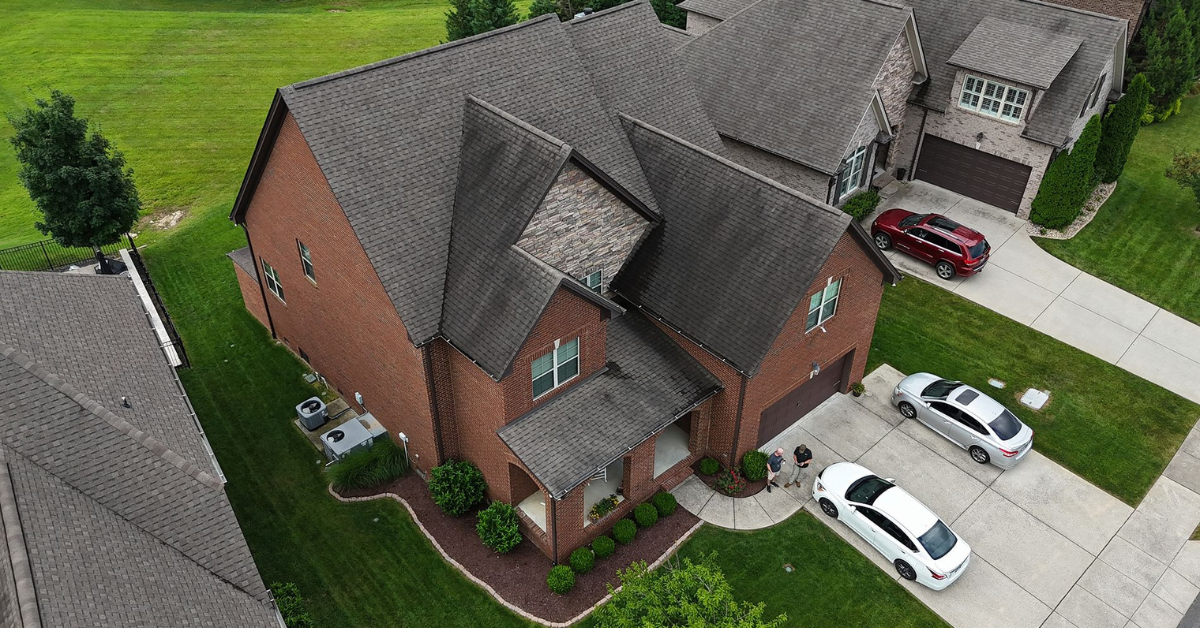 Aerial view of a newly replaced roof on a brick home in Franklin, Tennessee, showing expert craftsmanship and clean roof lines after a Five Points Roofing project.