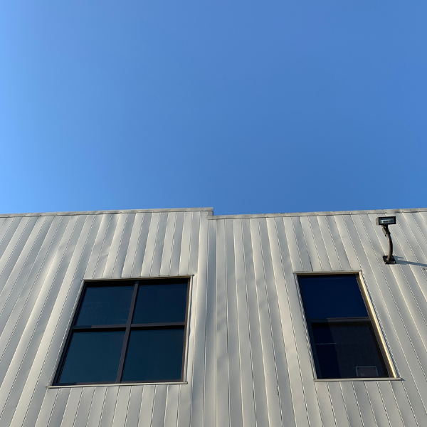 An image showing a residential property with metal siding.