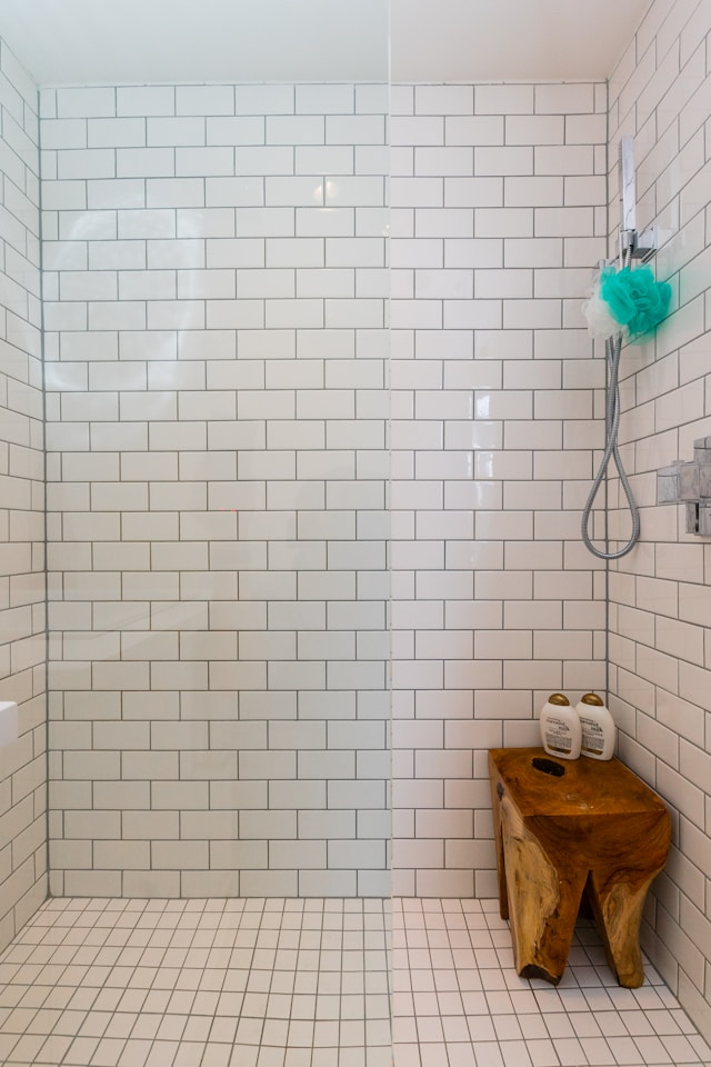 Walk-in shower walls completely covered in subway tiles