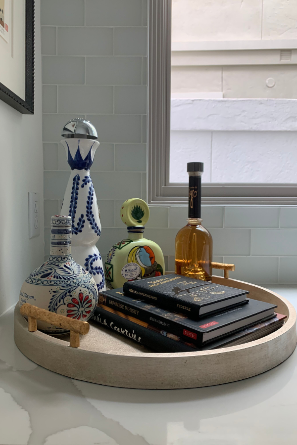 a bar vignette with tray, bottles, and books like Japanese Whisky by Brian Ashcraft