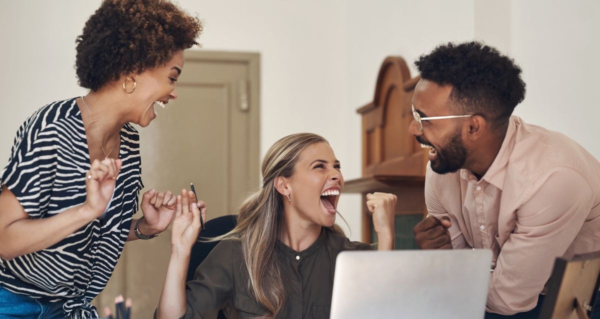 Employees celebrating because surrogacy is covered in their employee benefits 