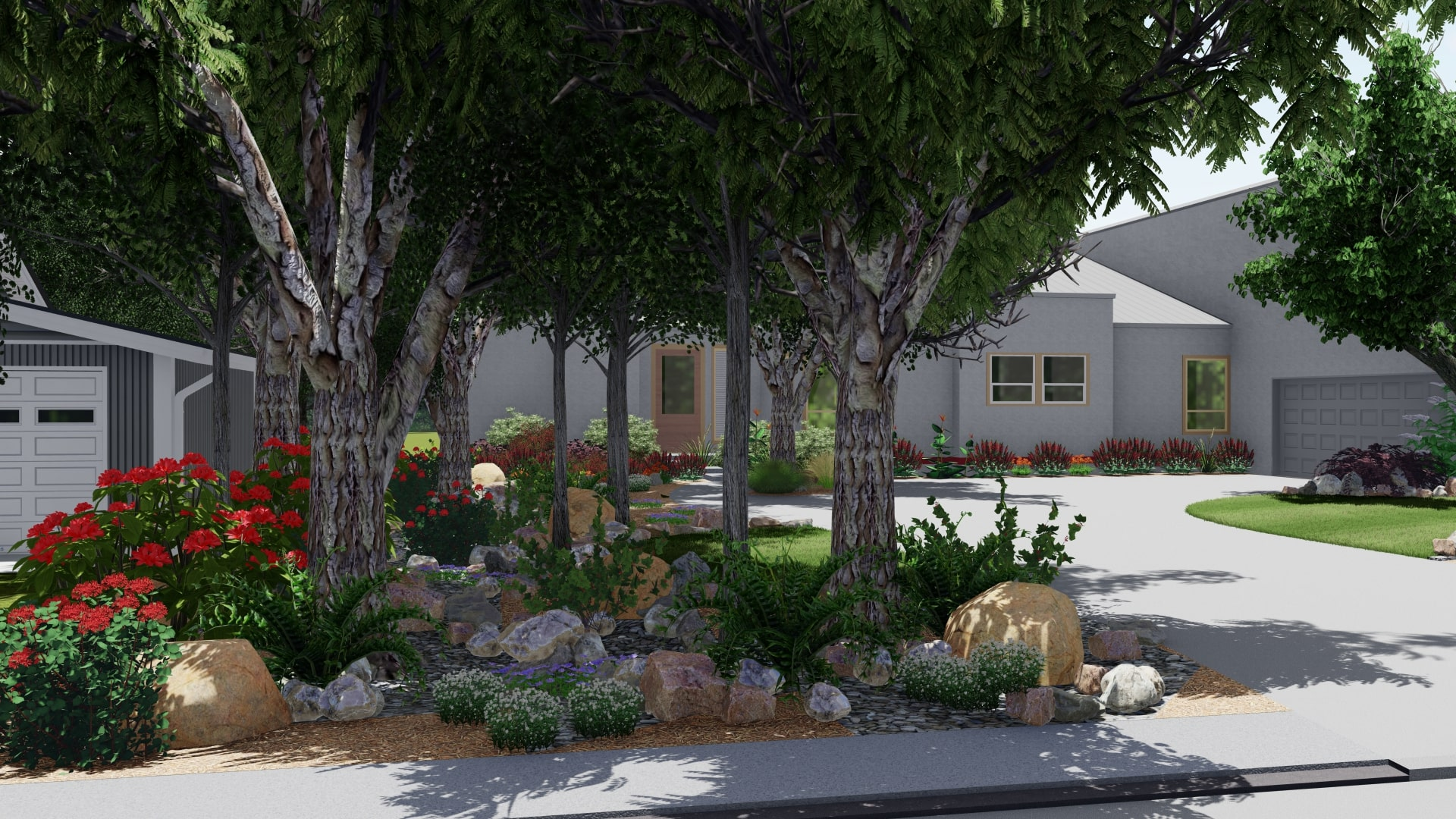 A low maintenance yard with rocks, flowers, ornamental grasses and more along the driveway