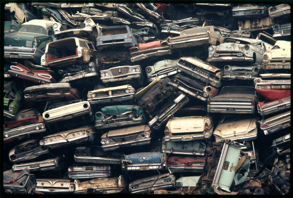 An image showing a pile of junk cars on a property, representing the question of how many junk cars can you have on your property