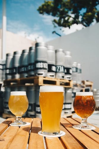 Three types of local craft beer in three different shaped clear glasses