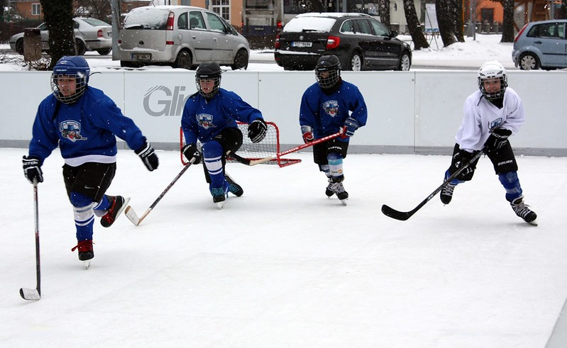 Boys playing ice hockey on synthetic ice