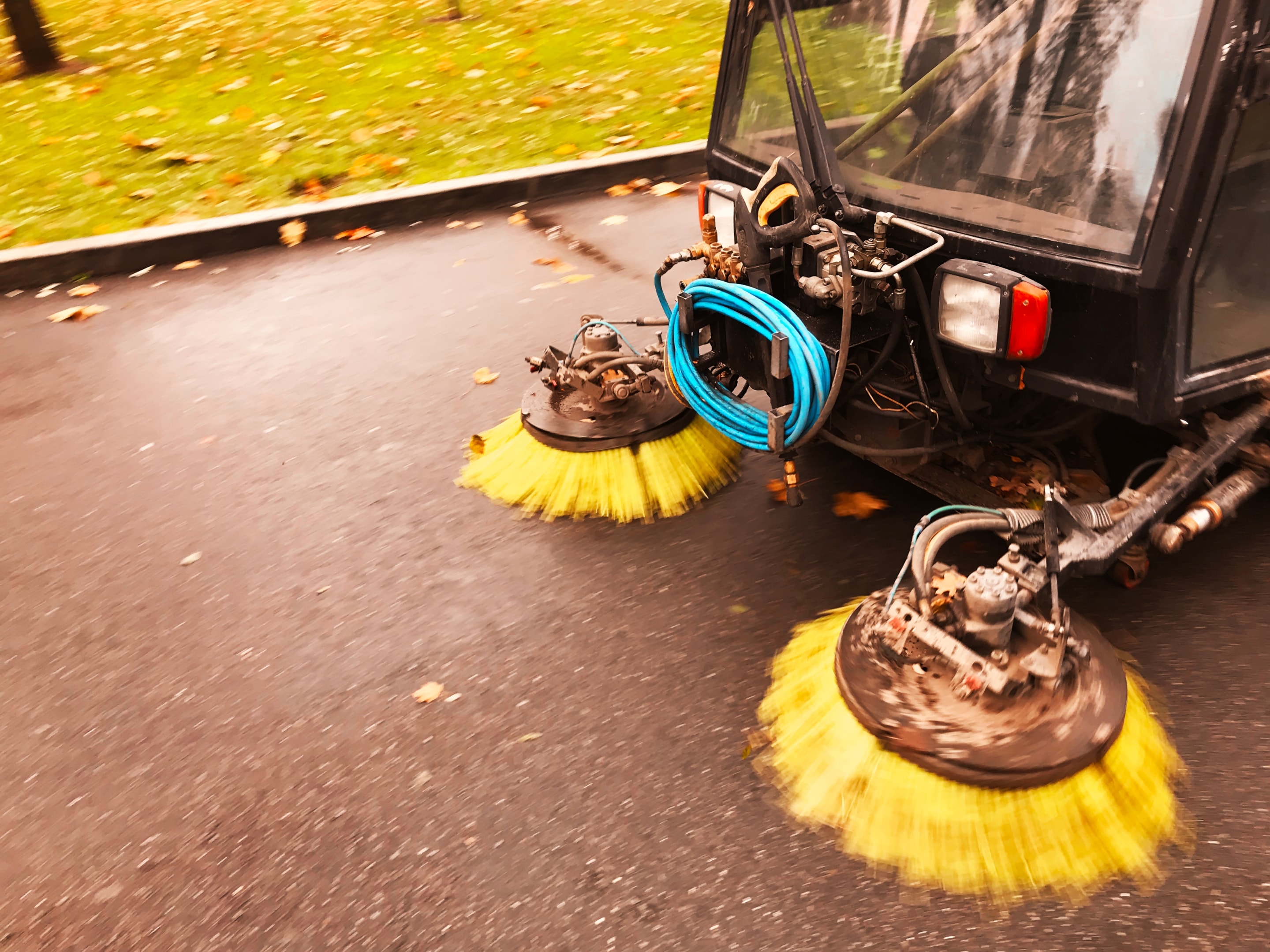 A professional team performing parking lot sweeping services.