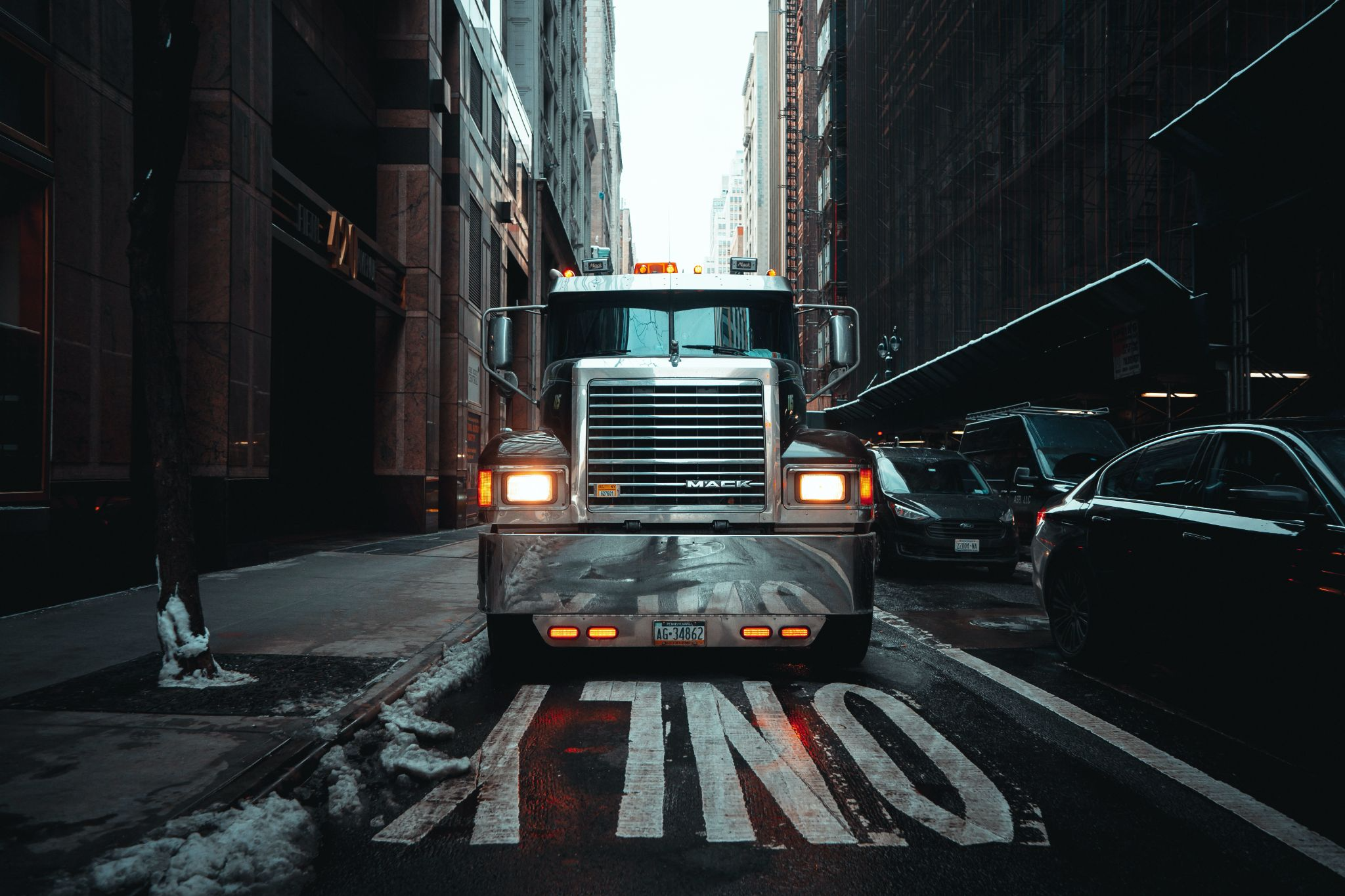 Grill of a semi truck in a narrow alley