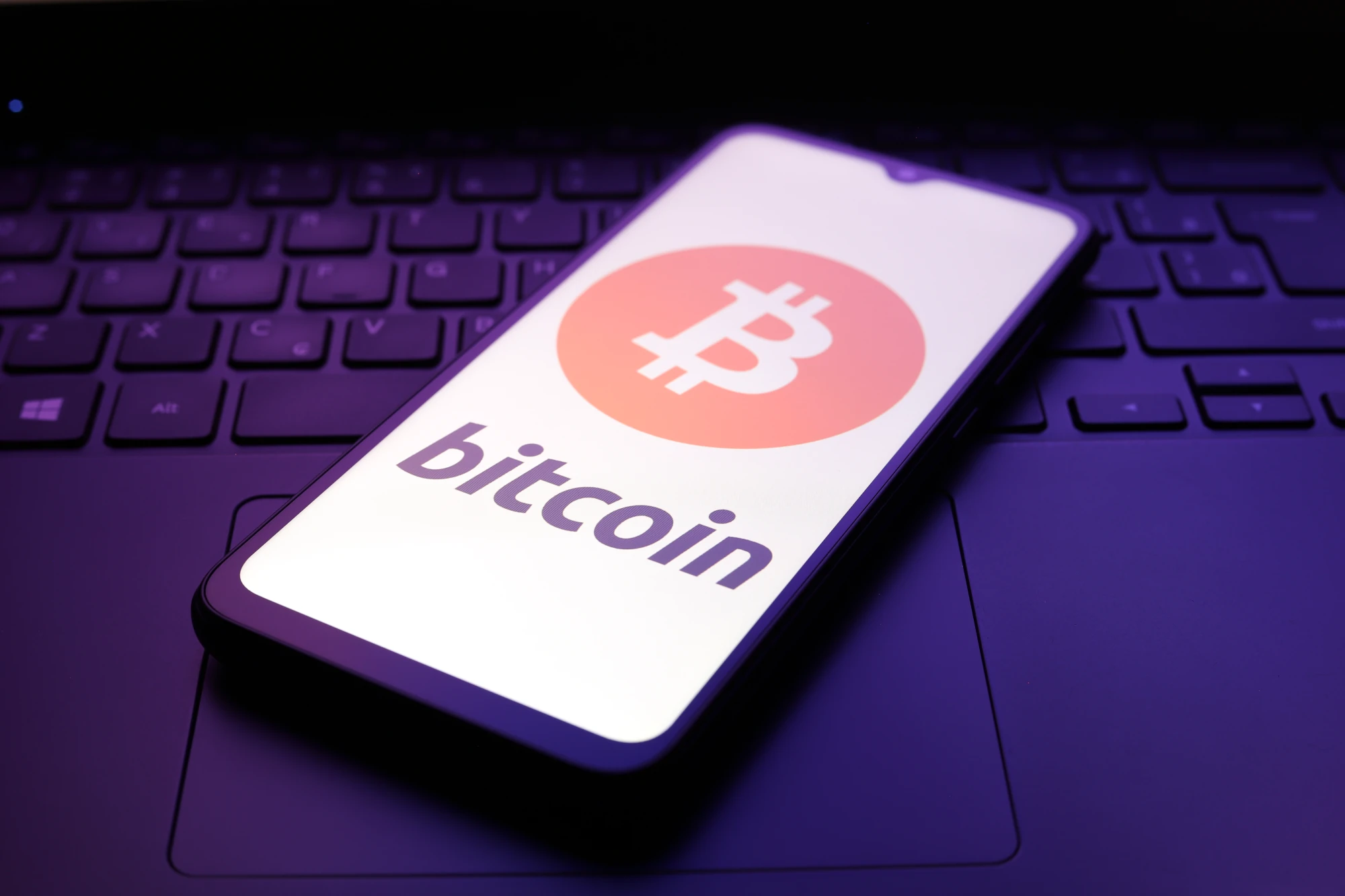 The Bitcoin logo appears on the screen of a smartphone sitting on top of a laptop in Reno, United States, on December 5, 2024. 