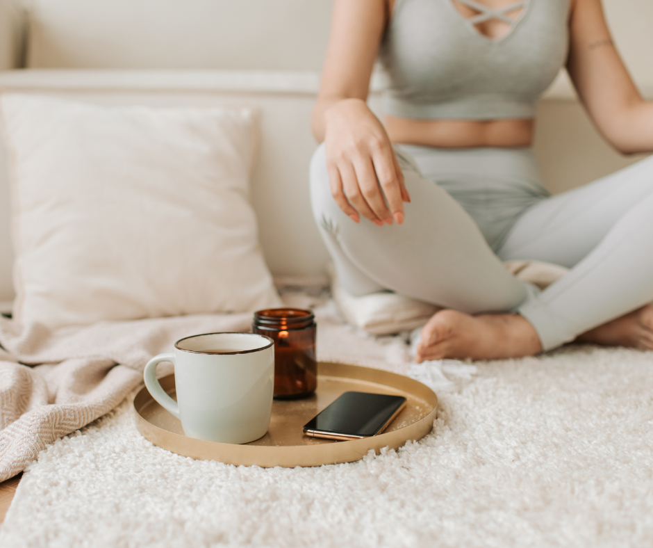 a woman sitting on her couch using her free time to meditate