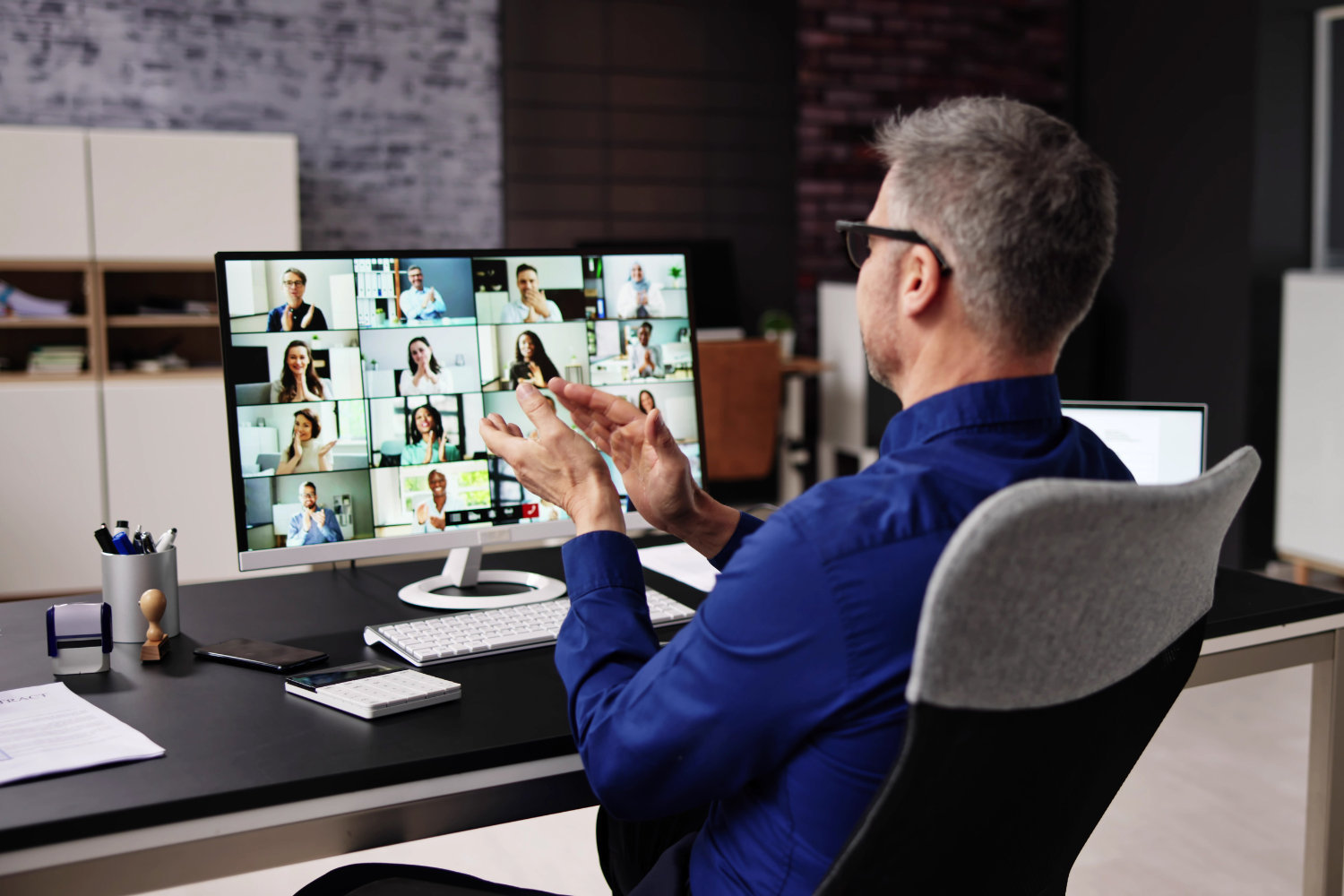 A founder on a video call with his remote workers.