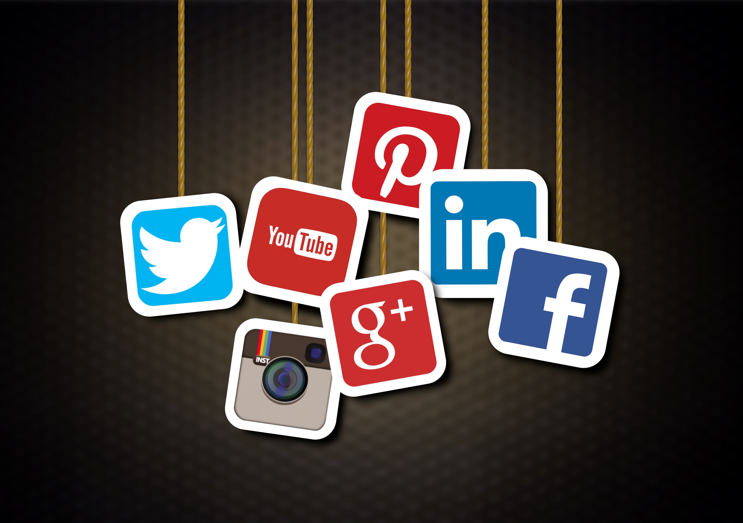 App icons dangling from ropes on a brown background