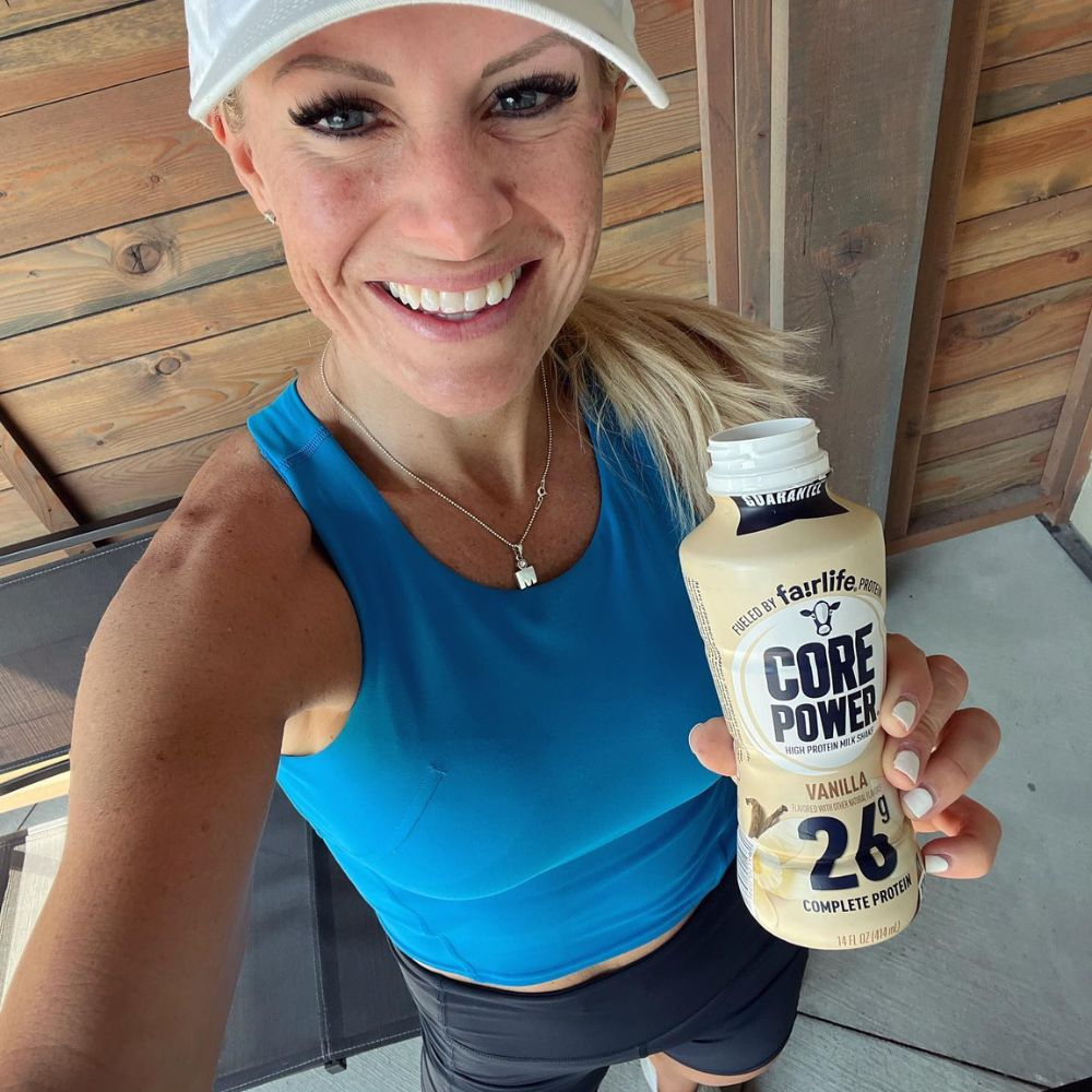 A person drinking a protein shake and smiling