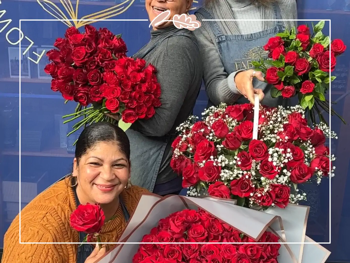 Three florists holding large bouquets of red roses and smiling, Fabulous Flowers and Gifts