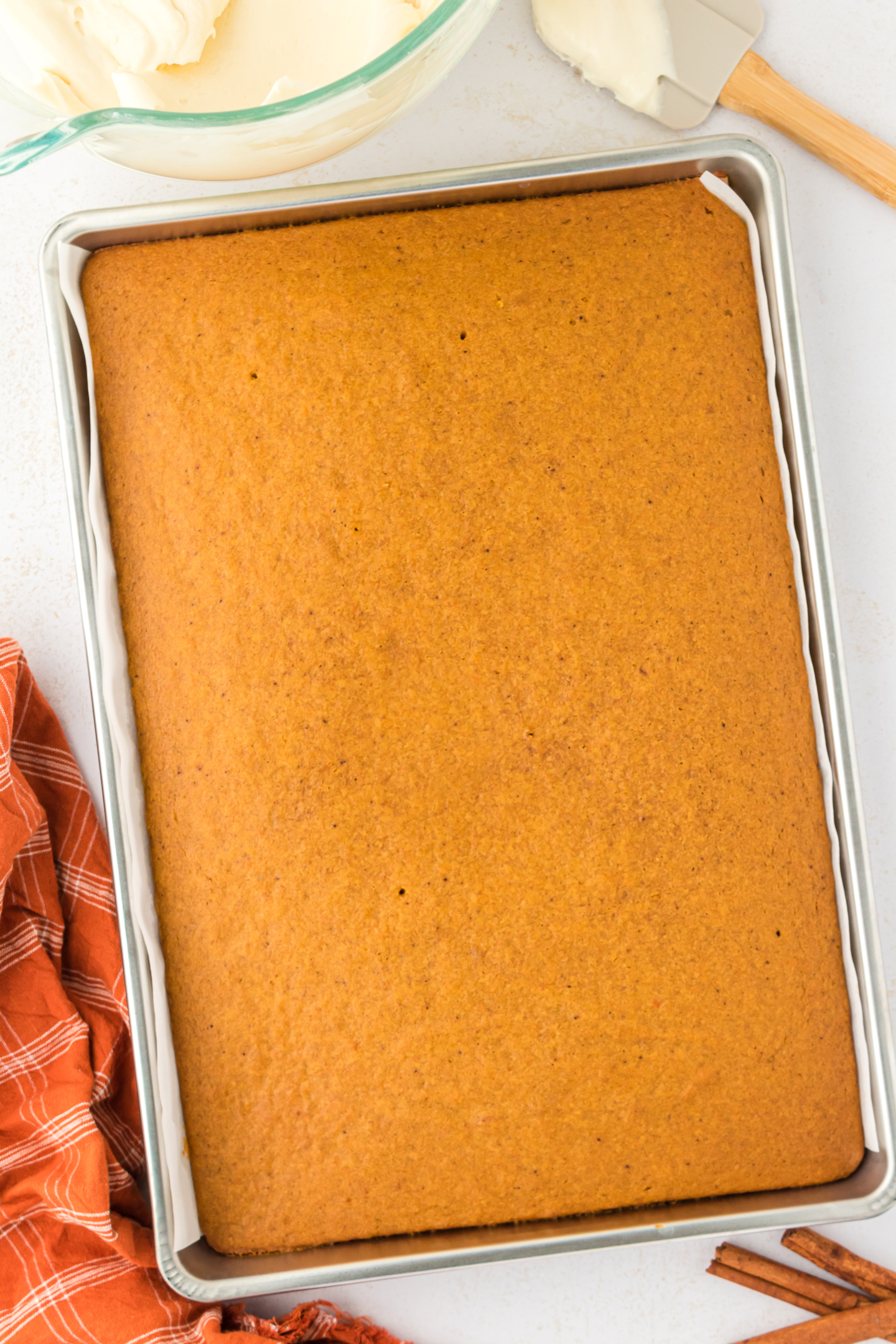 baked pumpkin bars with no frosting on them into prepared baking dish on a wire rack