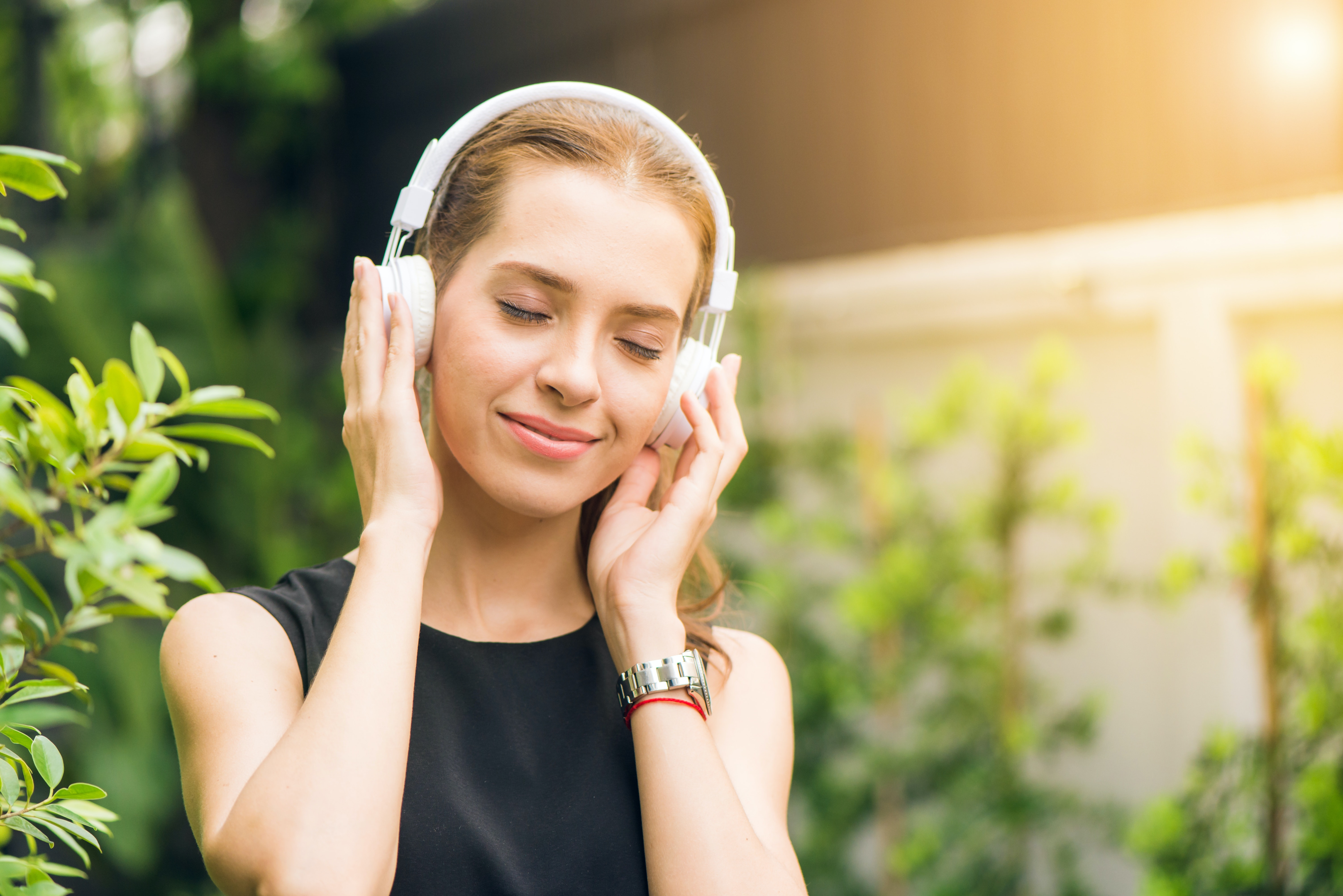 Women listening to sound healing music through headphones 