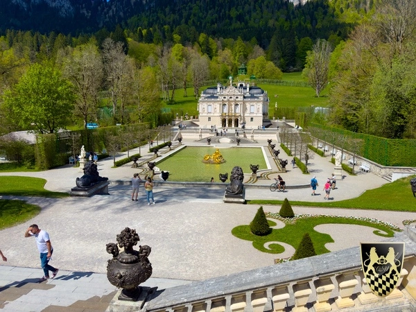 Neuschwanstein Tour Private Driver from Munich 9 A picturesque Alpine landscape showcases a traditional Bavarian village nestled among towering mountain peaks, with the iconic Neuschwanstein Castle visible in the distance. This scene captures the essence of Bavaria's stunning views and rich history, perfect for creating incredible memories during a private day trip with an English-speaking local driver.
