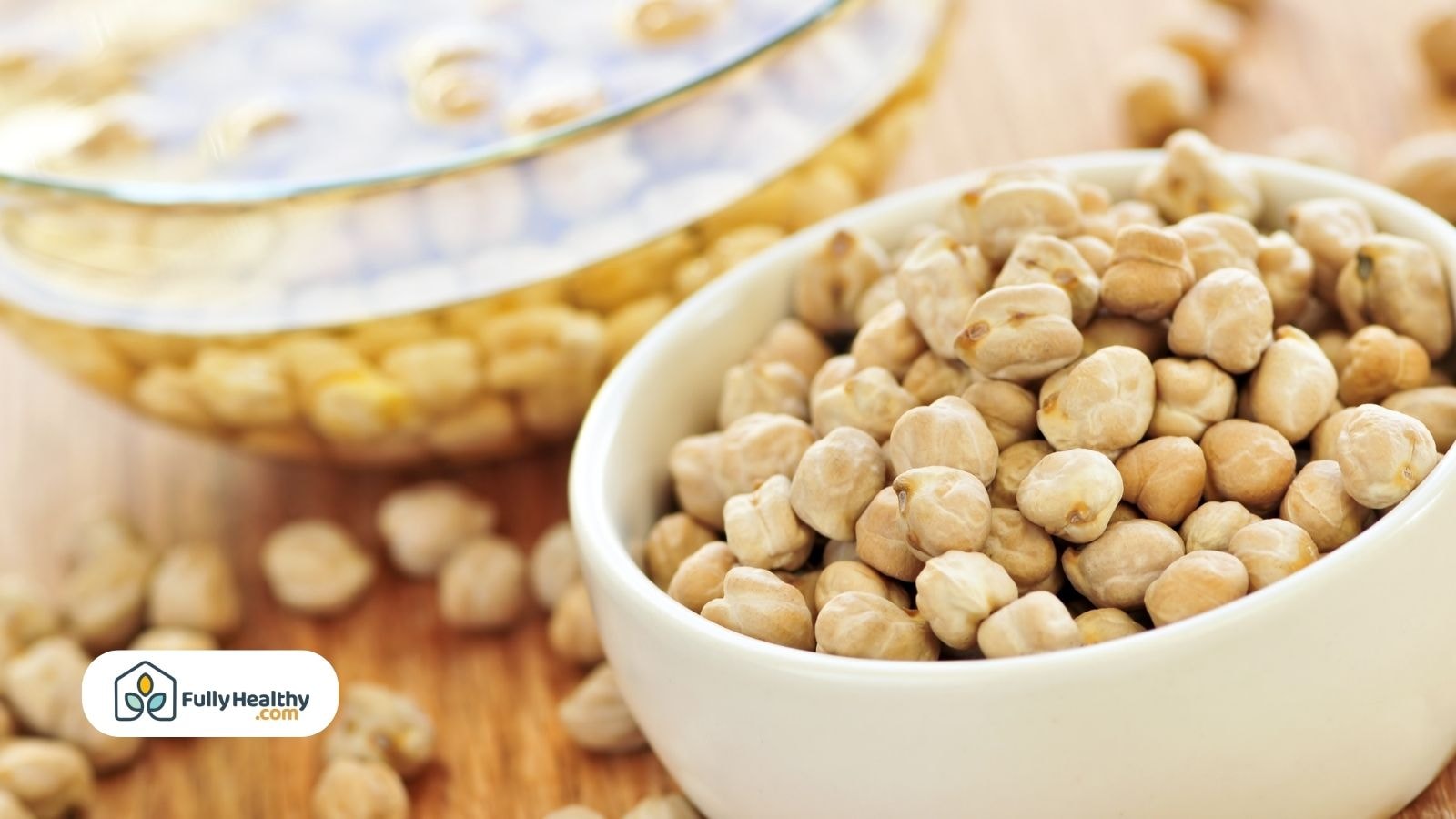 White bowl of dried chickpeas with soaking bowl behind