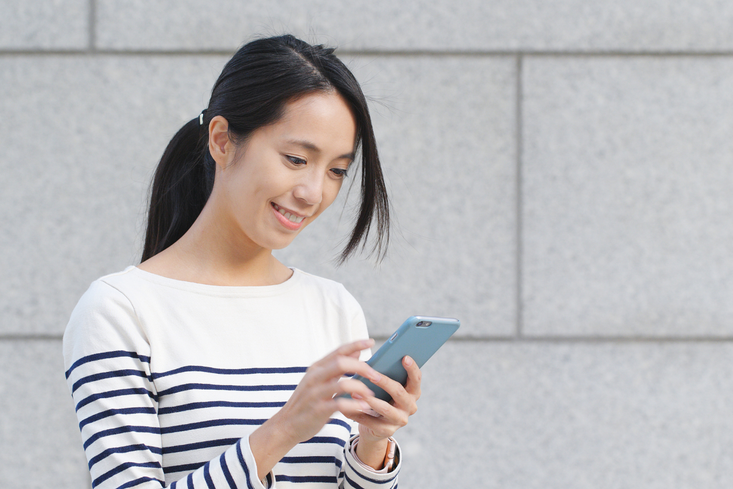 Woman looking at smartphone.