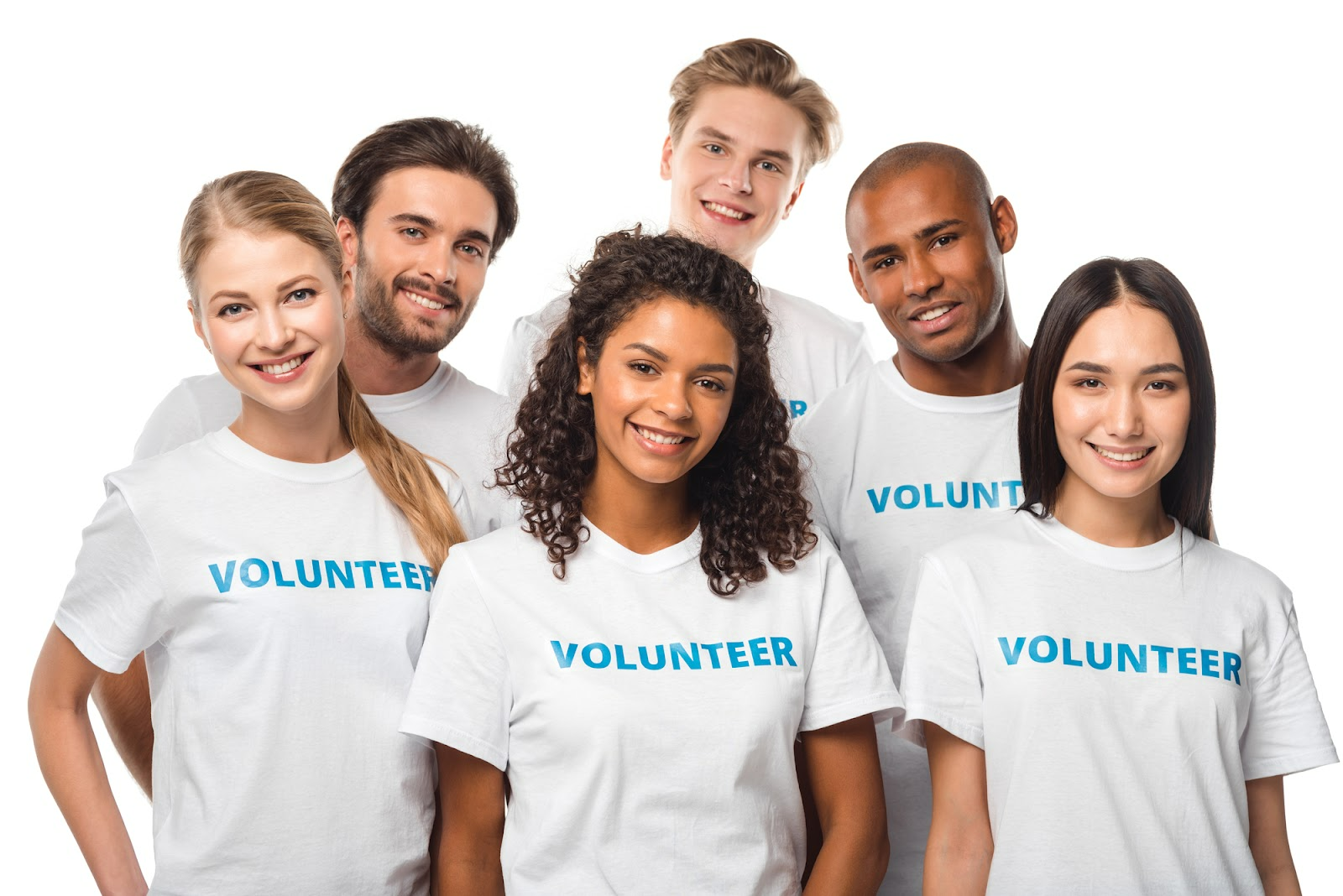 A group of people smiling for the camera, wearing shirts that read “volunteer.”