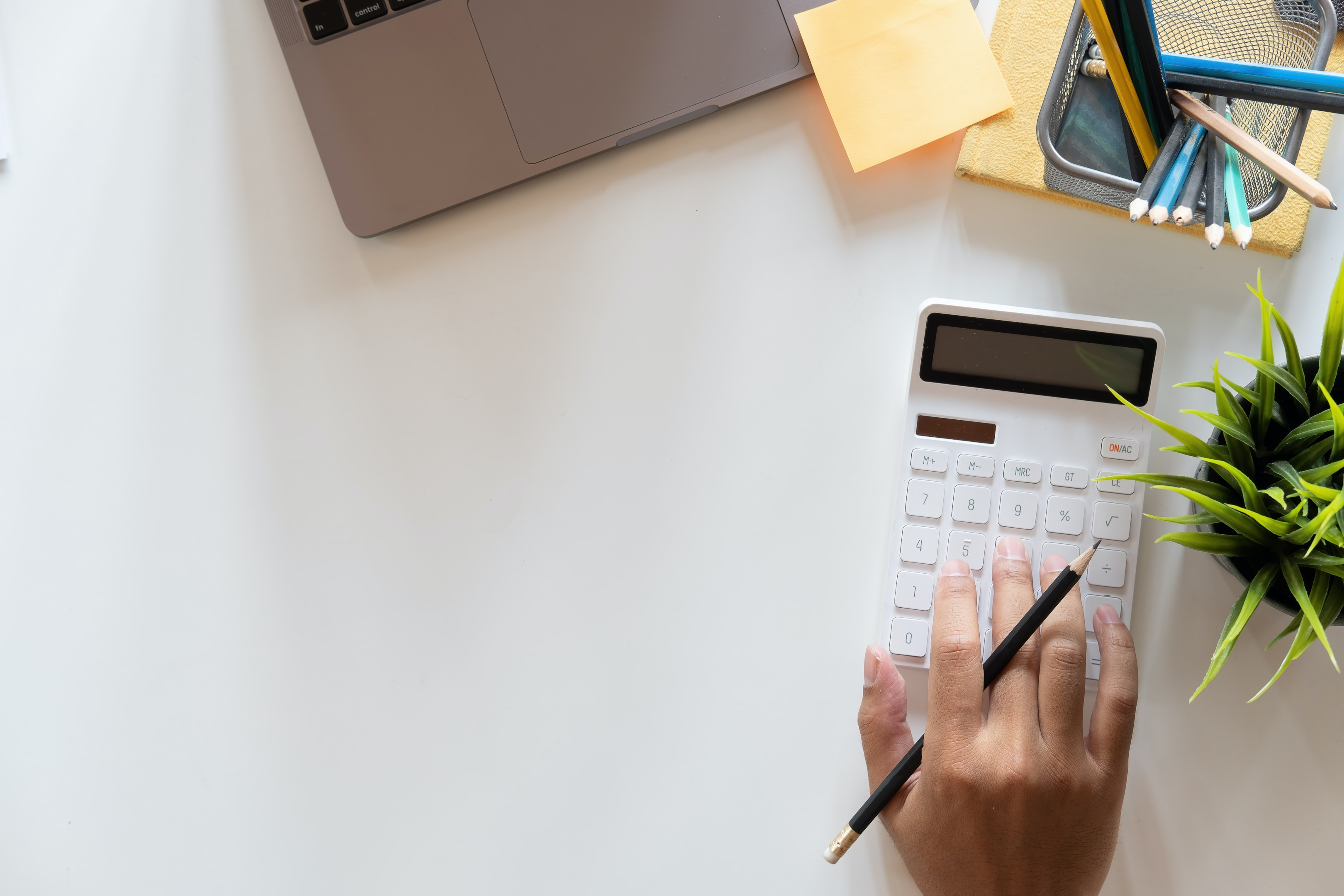 Someone typing on a calculator while holding a black pencil. As the top auto transport company, National Transport Services can handle shipping one car to complete fleets.