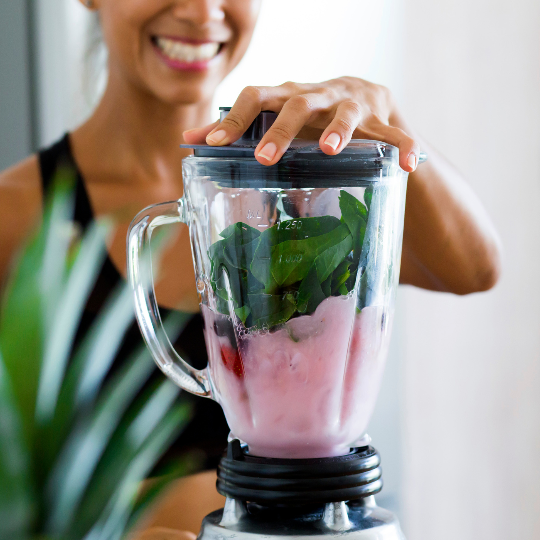 woman mixing food in a blender