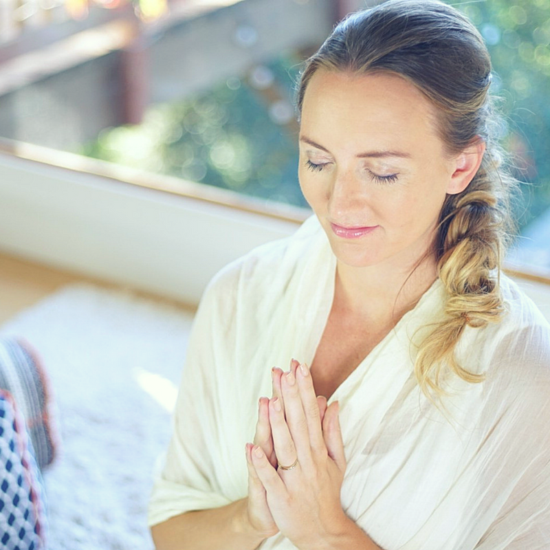 brett larkin with prayer hands in meditation