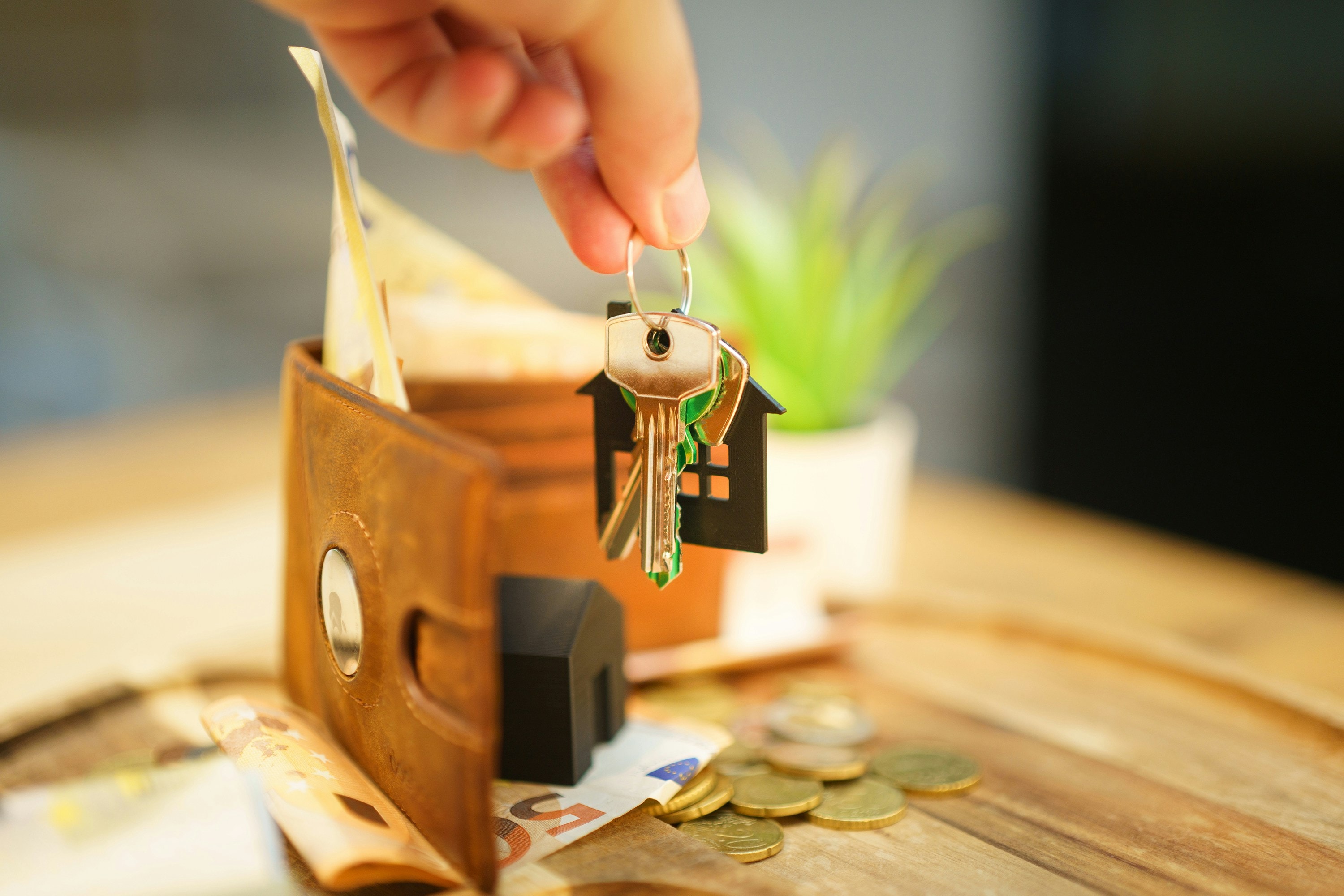 Real estate investor holds keys to property purchased through BRRRR method of investing.