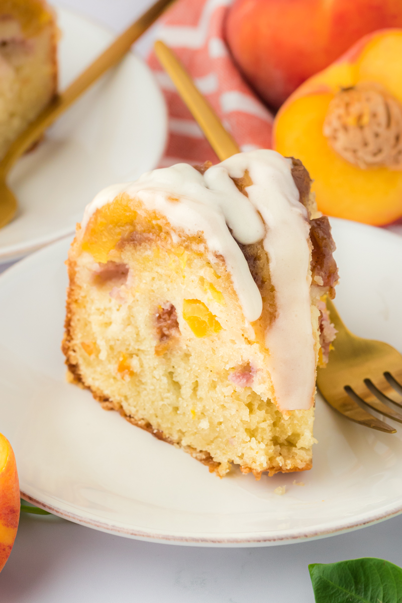 slice of peach pound cake on a plate with a fork