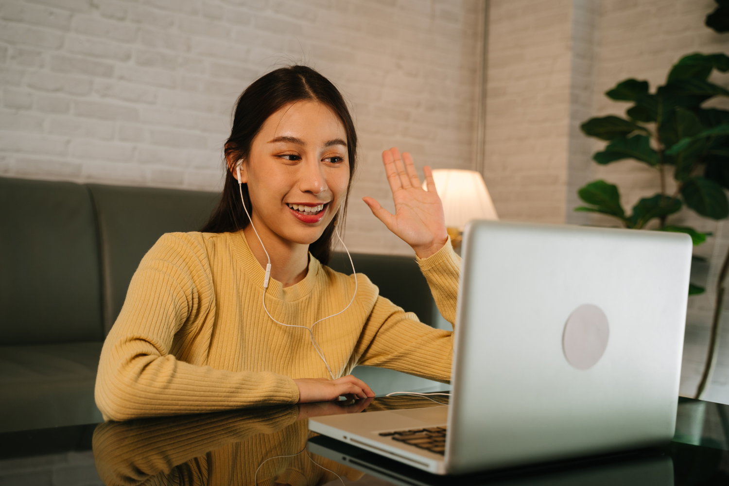 A remote worker saying Hi while on video call.