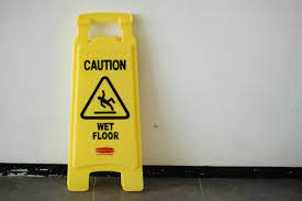 A sign indicating wet floor to prevent slip and floor accidents