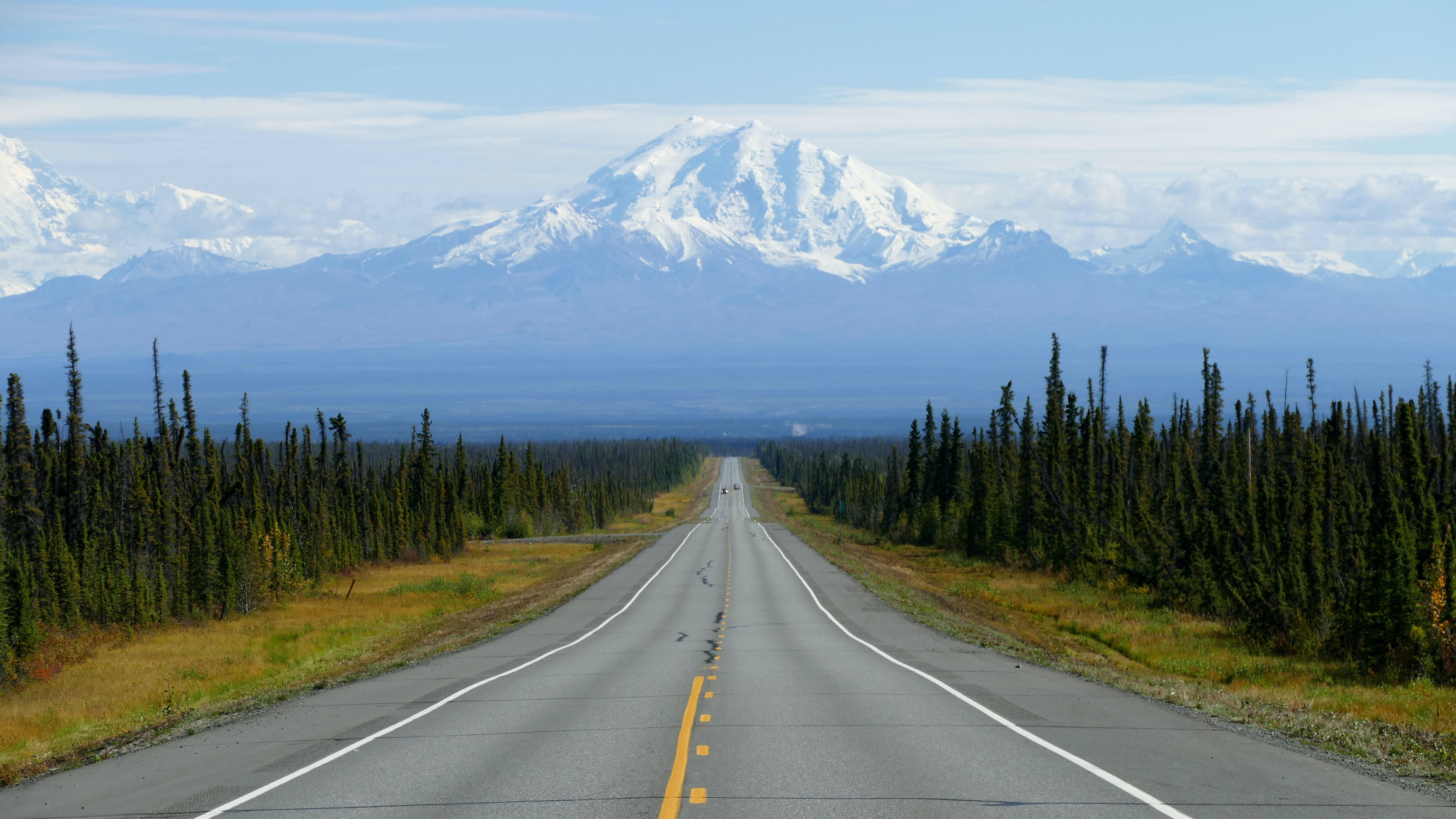 A long empty country road in Alaska. Want to ship a car to Alaska? Vehicle shipping nationwide is what we provide.