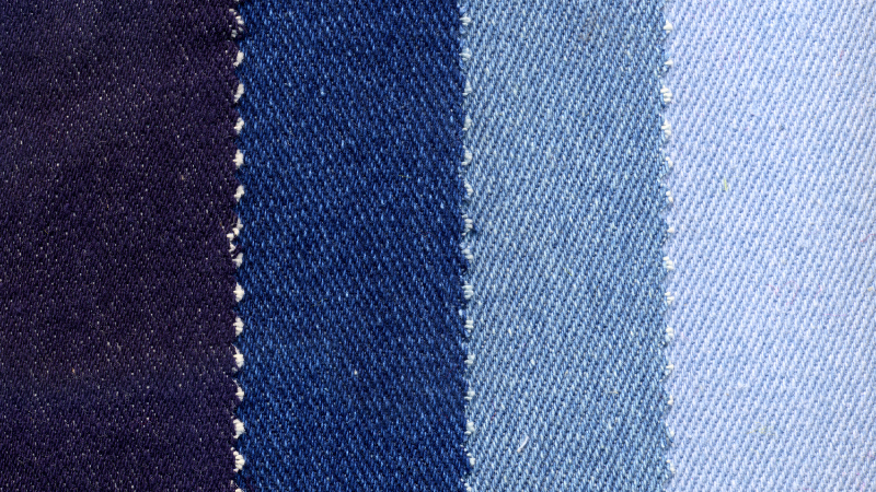 A close up of several different colors of denim fabric