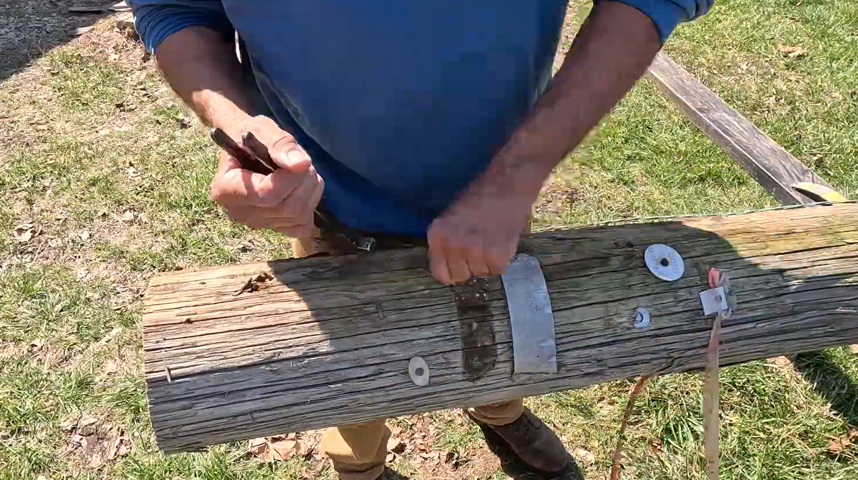 Tony removing metal from used utility poles to be milled into dozens of board feet of lumber. 