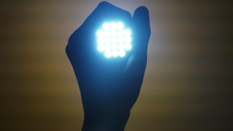 Hand holding an LED flashlight with multiple LEDs