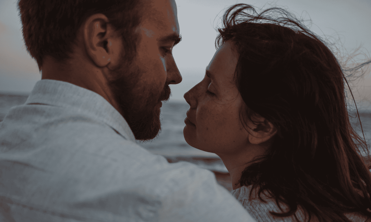 White couple leaning in as they get ready to have their first kiss.