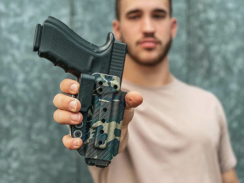 An image showing different types of holsters for a 1911 pistol.