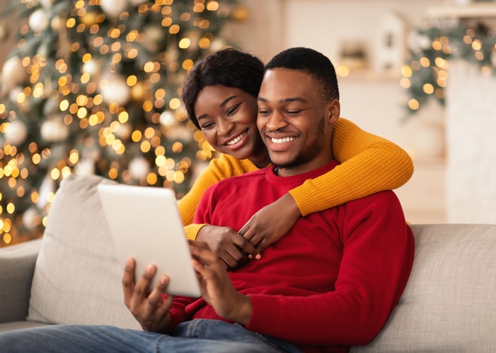 Husband and wife chatting online with family. 