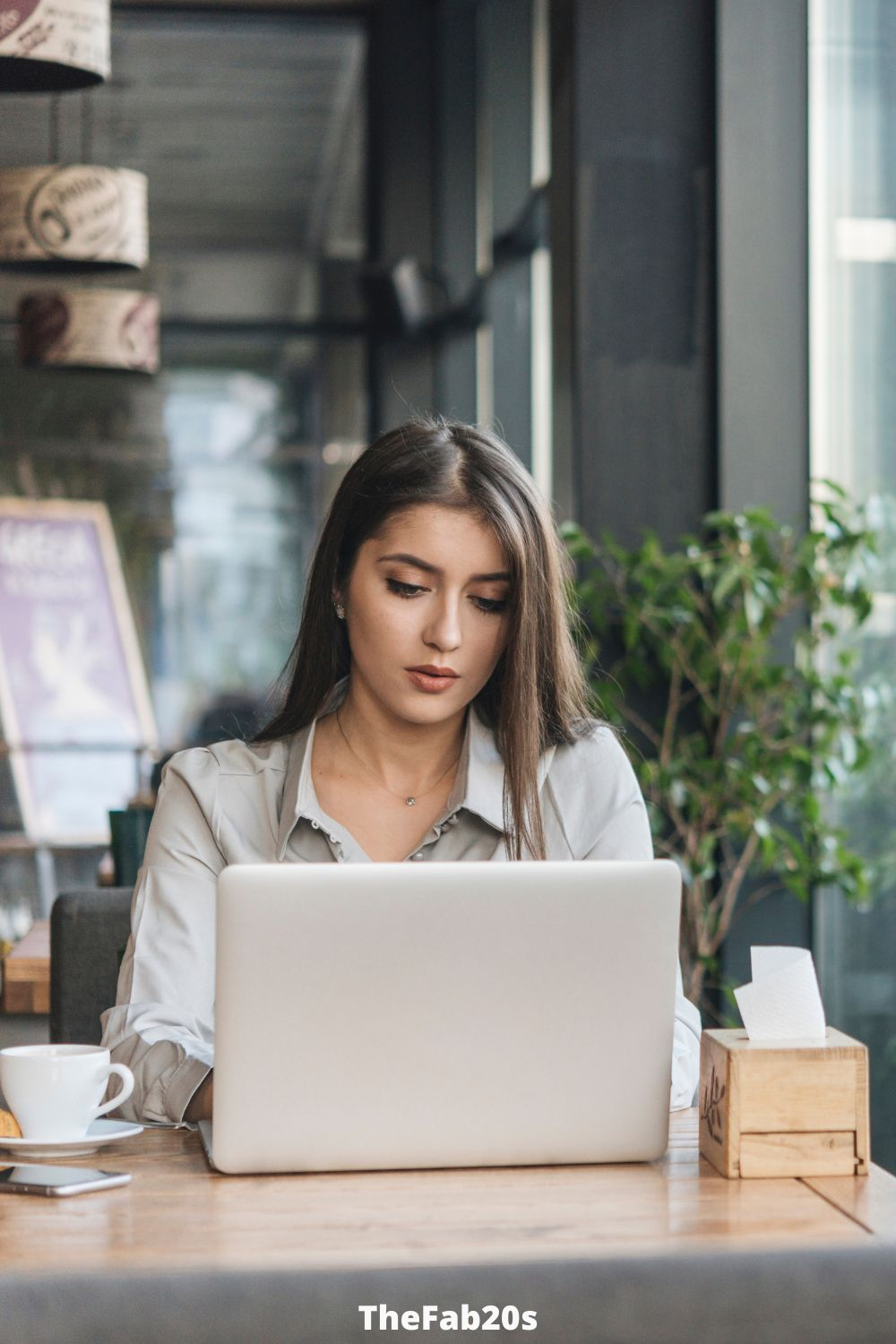 Woman in a coffee shop working on her laptop