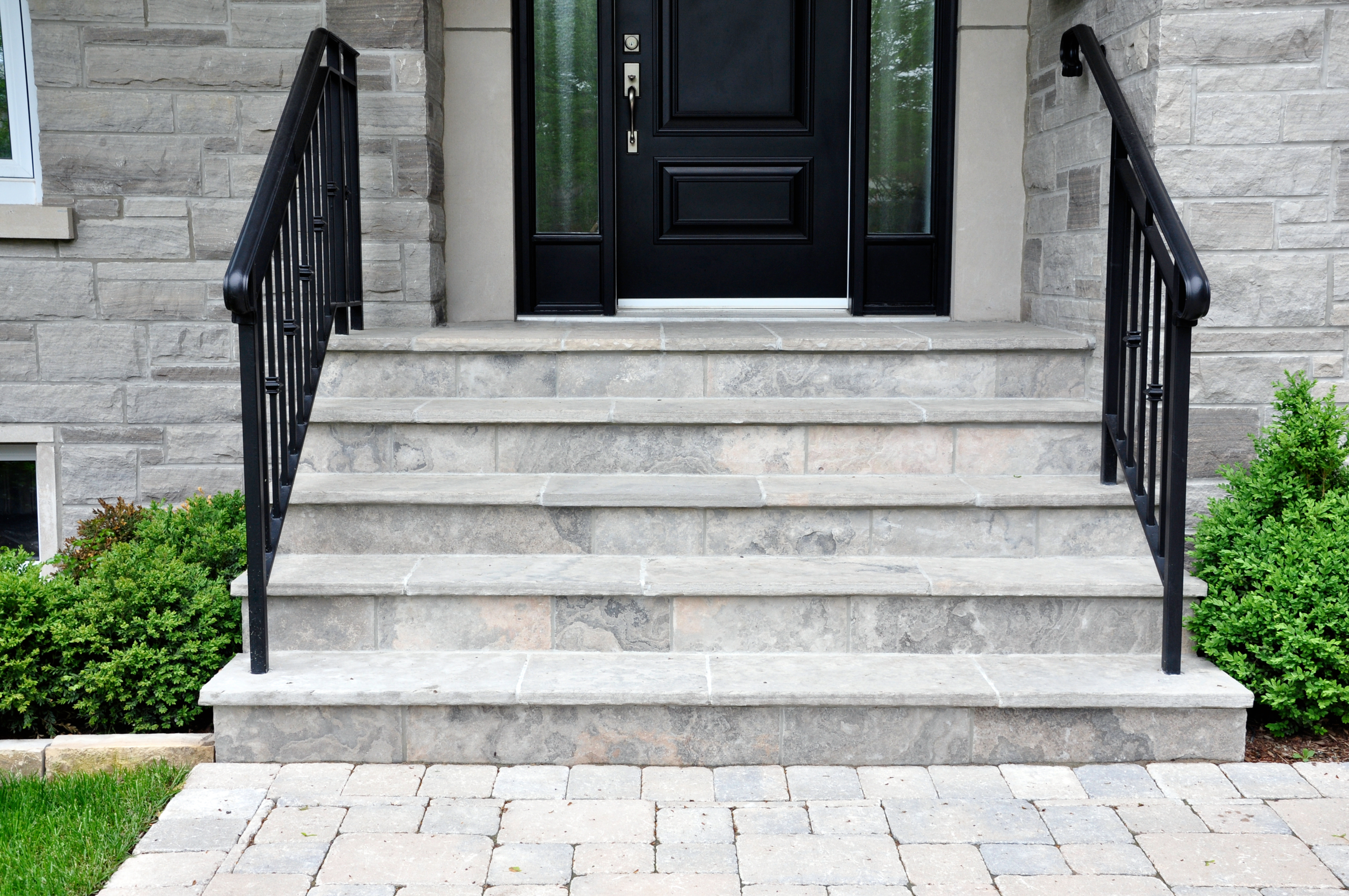 Front steps with matching black hand rails.