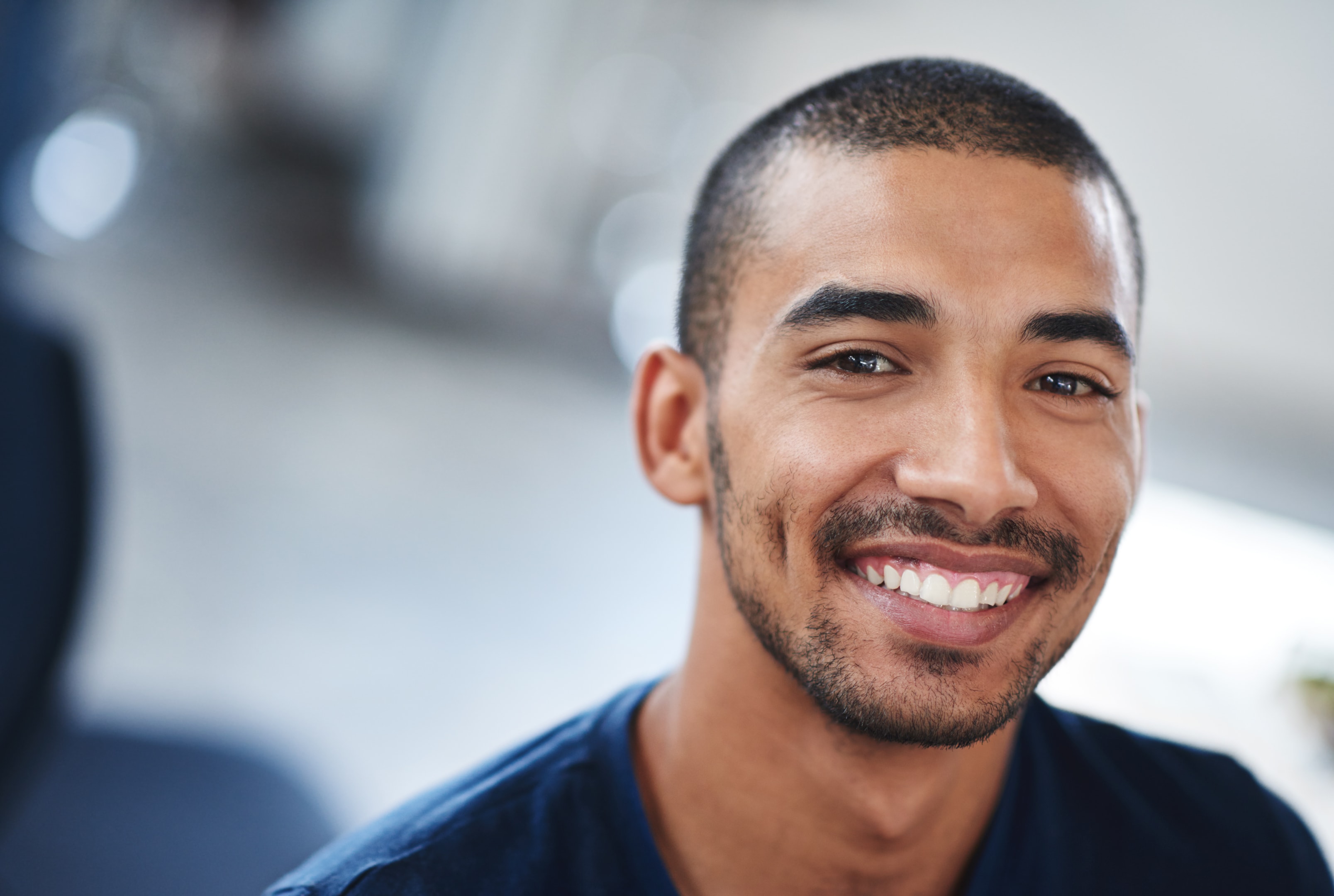 a smiling person who has gotten a bone graft in the past