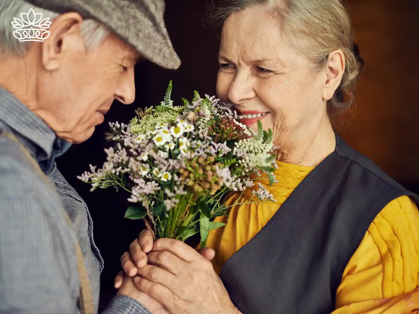 Elderly couple enjoying a beautiful bouquet of flowers with a soft, loving expression. Fabulous Flowers and Gifts, Luxury Flower Arrangements.