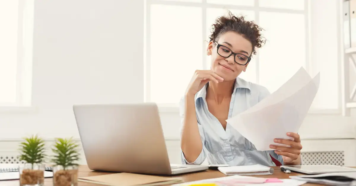 Woman managing financial documents related to charge-off vs. cancellation of debt.