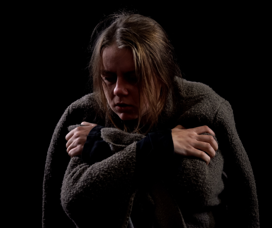 An image depicting a person experiencing withdrawal symptoms due to sudden sobriety, highlighting the question 'is it dangerous for an alcoholic to stop drinking?'
