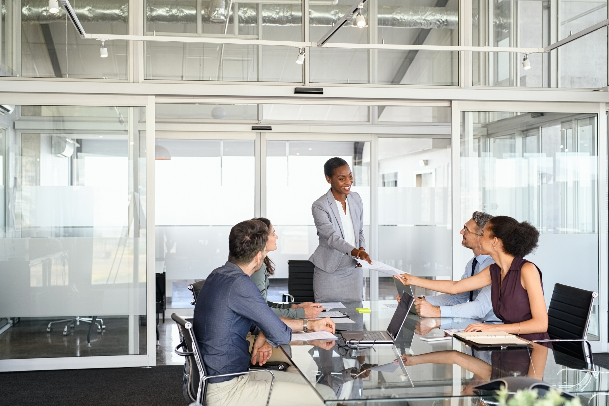 A person standing in front of a group of people, talking about business leadership