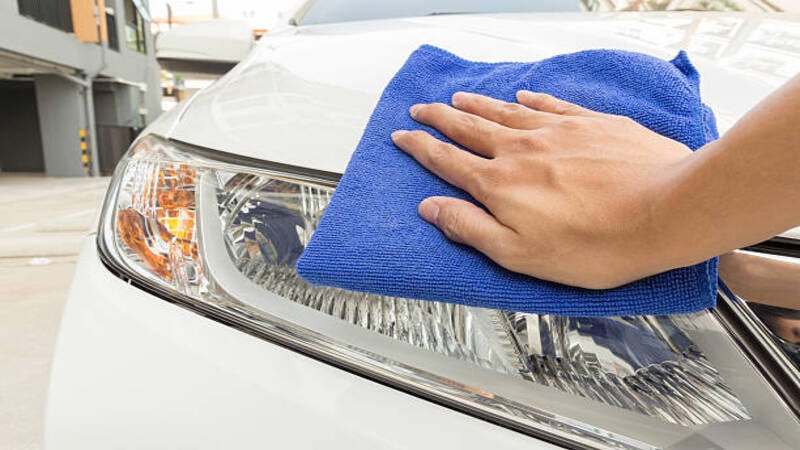 Cleaning of a headlight using a soft cloth. 