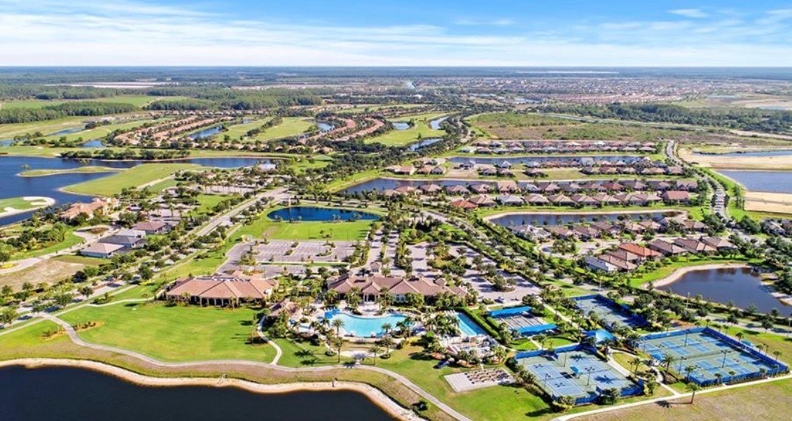 The image depicts a modern community gathering space featuring sleek architecture and beautifully landscaped outdoor areas, perfect for socializing and events. This inviting environment is complemented by resort-style amenities, including a spacious gathering room and nearby recreational options, enhancing the active lifestyle experience in Ave Maria.
