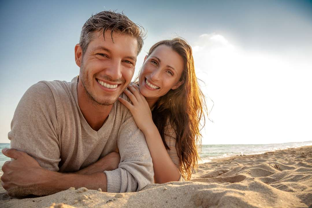 vitamin d supplementation, couple on the beach in the sun, vitamin d supplements