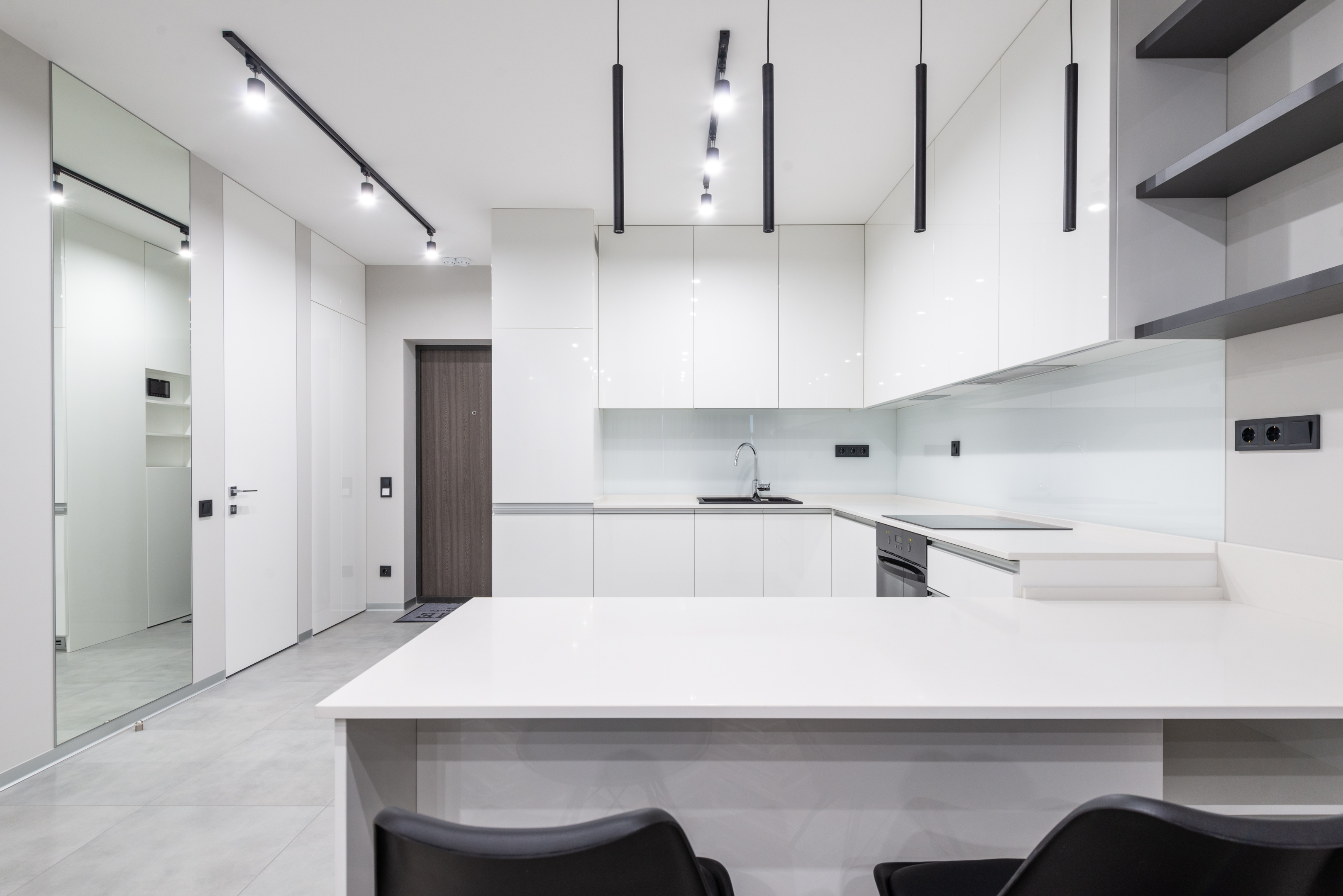 Contemporary white kitchen in a basement apartment